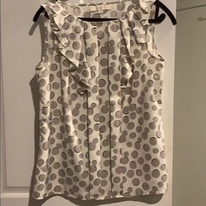 Sleeveless blouse w/pleated bib detail.